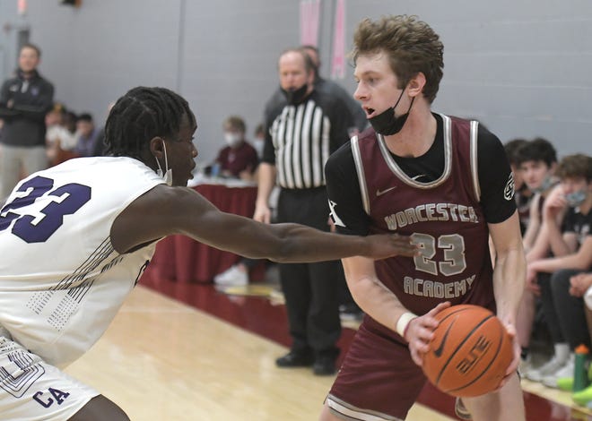 Worcester Academy's TJ Power protects the ball from Cushing Academy's Marvin Musiime-Kamali.