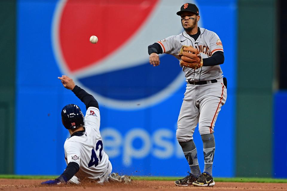 San Francisco Giants shortstop Brandon Crawford, right, gets out Cleveland Guardians&#39; Steven Kwan, left, at second base in the fourth inning of a baseball game, Friday, April 15, 2022, in Cleveland. Franmil Reyes was out at first for a double play. (AP Photo/David Dermer)