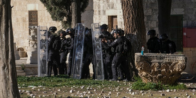 Israeli security forces take position during clashes with Palestinians demonstrators at the Al Aqsa Mosque compound in Jerusalem's Old City, Friday, April 15, 2022. 