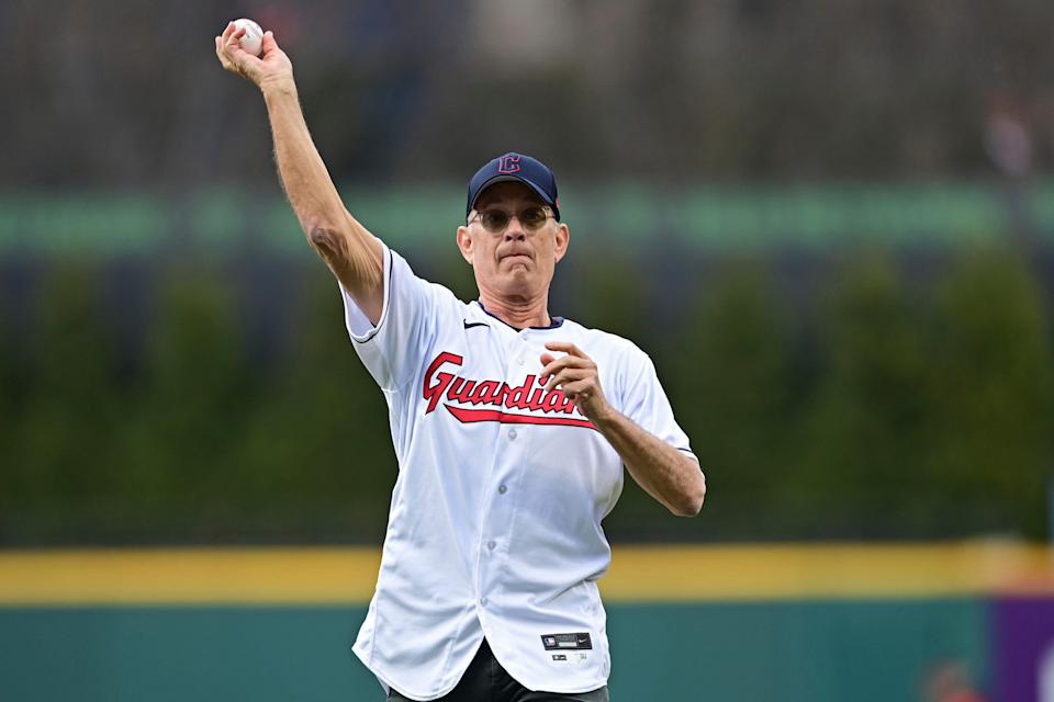 Actor Tom Hanks throws out the ceremonial first pitch before a baseball game between the San Francisco Giants and the Cleveland Guardians, Friday, April 15, 2022, in Cleveland. (AP Photo/David Dermer)
