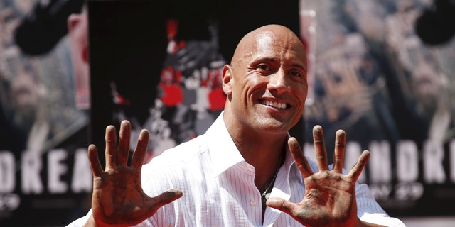 File photo - Actor Dwayne "The Rock" Johnson poses after putting his hands in cement during his hand and footprints ceremony in the forecourt of the TCL Chinese Theatre in celebration of his movie "San Andreas," in Hollywood, Calif. May 19, 2015.