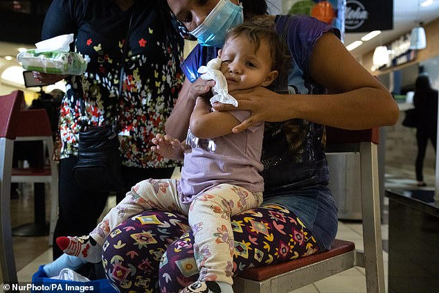 Among the 23 migrants were women and children. Cordalis, who is from Venezuela, cleans her child with supplies provided by the Catholic Charities organization