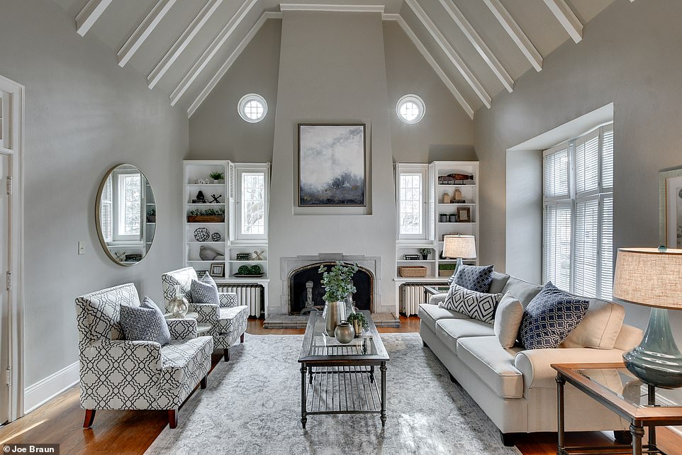 It also features features a beautiful vaulted ceiling with white exposed beams and gray walling