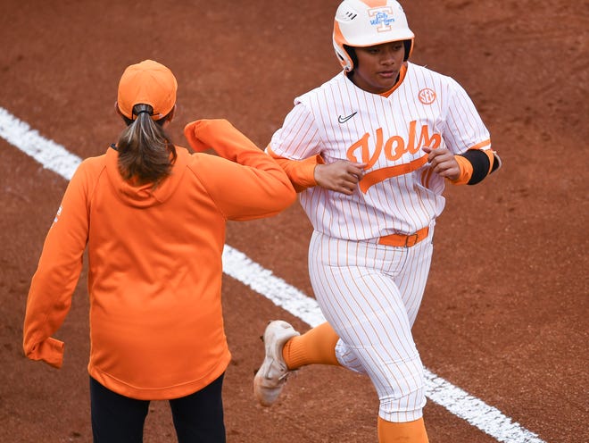 Tennessee's Zaida Puni (11) bumps elbows with softball coach Karen Weekly on a 2-run homer during the NCAA softball game agianst Texas A&M in Knoxville,Tenn. on Monday, April 18, 2022. 