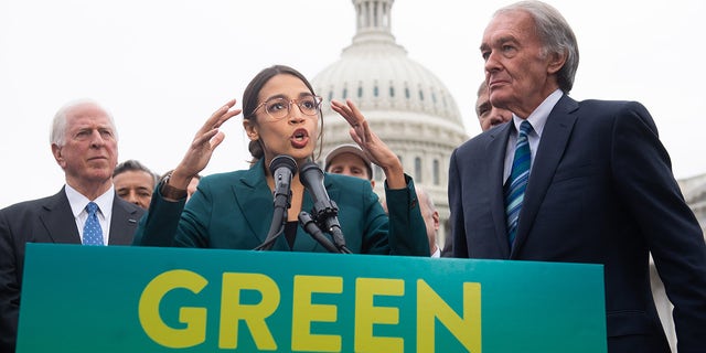 US Representative Alexandria Ocasio-Cortez, Democrat of New York, and US Senator Ed Markey (R), Democrat of Massachusetts, speak during a press conference to announce Green New Deal legislation to promote clean energy programs outside the US Capitol in Washington, DC, February 7, 2019. (Photo by SAUL LOEB / AFP)        (Photo credit should read SAUL LOEB/AFP via Getty Images)