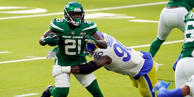 New York Jets running back Frank Gore (21) is tackled by Los Angeles Rams defensive end Michael Brockers (90) during a game Dec. 20, 2020, in Inglewood, Calif.