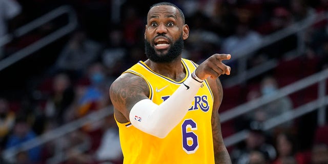 Los Angeles Lakers forward LeBron James talks to teammates during the first half of an NBA basketball game against the Houston Rockets, Tuesday, Dec. 28, 2021, in Houston.