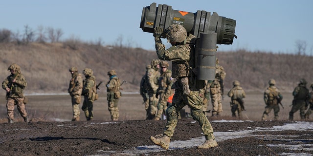 A Ukrainian serviceman carries an anti-tank weapon during an exercise in the Donetsk region, eastern Ukraine, Feb. 15, 2022.