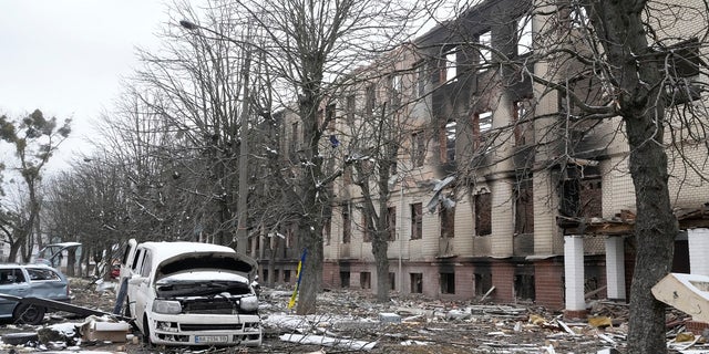 Damaged cars and a destroyed accommodation building are seen near a checkpoint in Brovary, outside Kyiv, Ukraine, Tuesday, March 1, 2022.