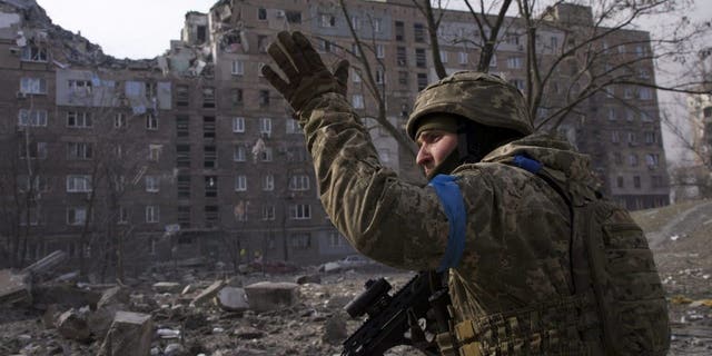 A Ukrainian serviceman guards his position in Mariupol, Ukraine, March 12, 2022. 