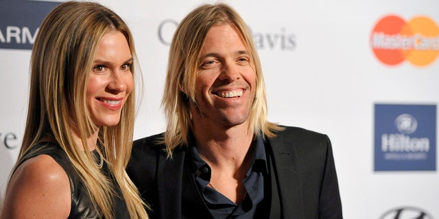 Foo Fighters drummer Taylor Hawkins, right, and Alison Hawkins arrive at the Clive Davis Pre-GRAMMY Gala on Saturday, Feb. 9, 2013, in Beverly Hills, Calif.