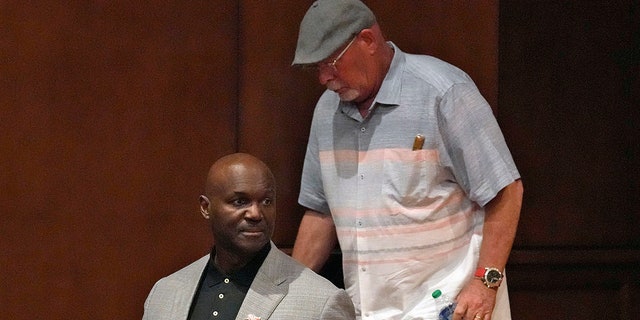 New Tampa Bay Buccaneers head coach Todd Bowles, left, arrives with predecessor Bruce Arians before a news conference Thursday, March 31, 2022, in Tampa, Fla.