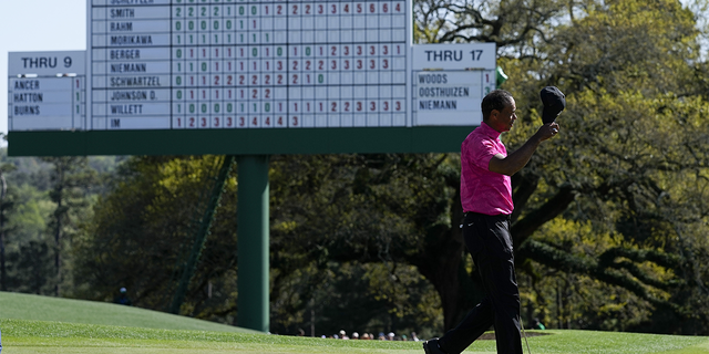 Tiger Woods tips his cap after playing out the 18th hole during the first round at the Masters golf tournament on Thursday, April 7, 2022, in Augusta, Ga.