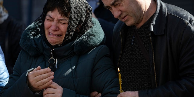 Relatives mourn the dead of Oleksandr Mozheiko, 31, territorial defense soldier who was killed by Russian army on March 5, during his funeral in Irpin, in the outskirts of Kyiv, Ukraine, Friday , April 15, 2022.