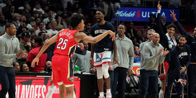 New Orleans Pelicans guard Trey Murphy III celebrates along with teammates on the bench after scoring during the second half of an NBA basketball play-in tournament game against the Los Angeles Clippers Friday, April 15, 2022, in Los Angeles. The Pelicans won 105-101.