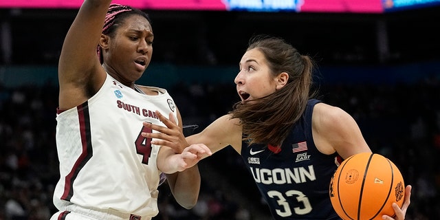 UConn's Caroline Ducharme tries to get past South Carolina's Aliyah Boston during the first half of a college basketball game in the final round of the Women's Final Four NCAA tournament Sunday, April 3, 2022, in Minneapolis.