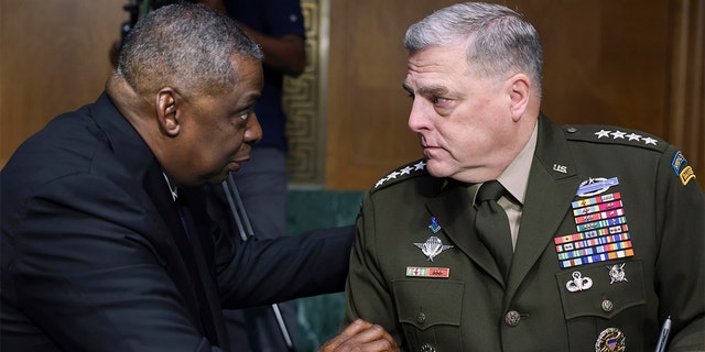 Defense Secretary Lloyd Austin, left, and Chairman of the Joint Chiefs Chairman Gen. Mark Milley talk before a Senate Appropriations Committee hearing on Capitol Hill on June 17, 2021.