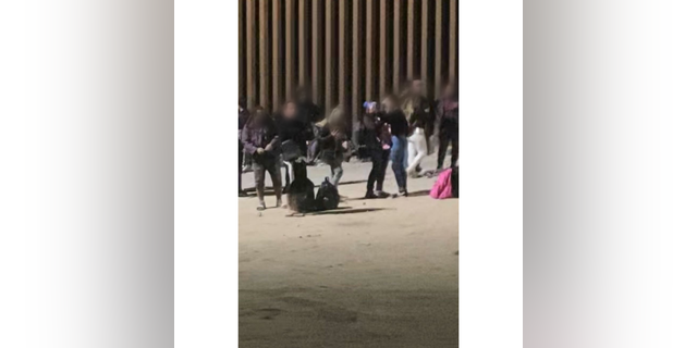 Migrants take selfies at the border. 