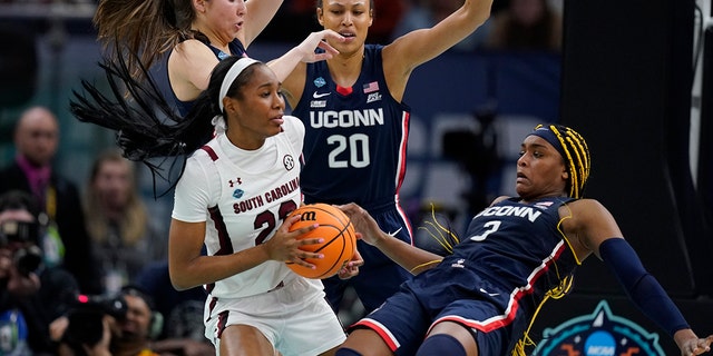 South Carolina's Bree Hall battles with UConn's Aaliyah Edwards during the second half of a college basketball game in the final round of the Women's Final Four NCAA tournament Sunday, April 3, 2022, in Minneapolis.