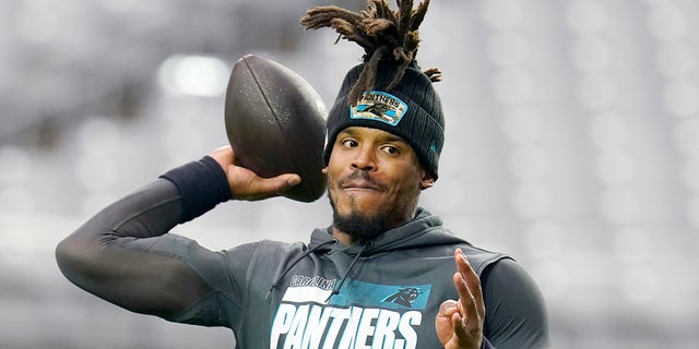 Carolina Panthers quarterback Cam Newton warms up prior to an NFL football game against the Arizona Cardinals Sunday, Nov. 14, 2021, in Glendale, Ariz.