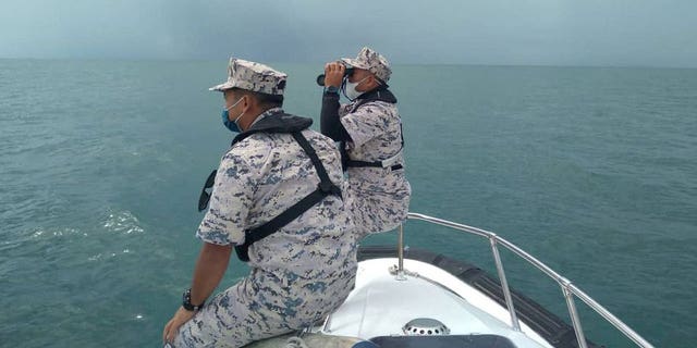 Malaysian Maritime Enforcement Agency officers search for missing divers off the Mersing coast, Johor, Malaysia, April 8, 2022. 