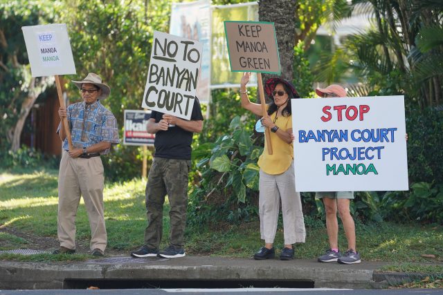 Demonstrators opposing Manoa Banyan Court project gather near University Avenue and East Manoa Road.