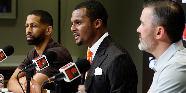 Cleveland Browns' new quarterback Deshaun Watson speaks during a news conference in Berea, Ohio, on March 25, 2022, as general manager Andrew Berry, left, and head coach Kevin Stefanski listen.