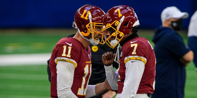 Nov 26, 2020; Arlington, Texas, USA; Washington Football Team quarterback Dwayne Haskins (7) and quarterback Alex Smith (11) warms up before the game against the Dallas Cowboys at AT&amp;T Stadium.