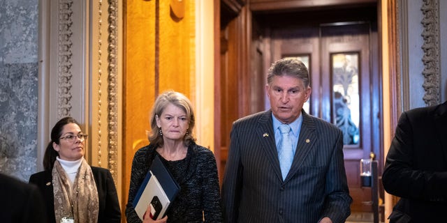 Sen. Lisa Murkowski (R-AK) talks with Sen. Joe Manchin (D-WV) outside the Senate Chamber at the U.S. Capitol on April 7, 2022 in Washington, DC.