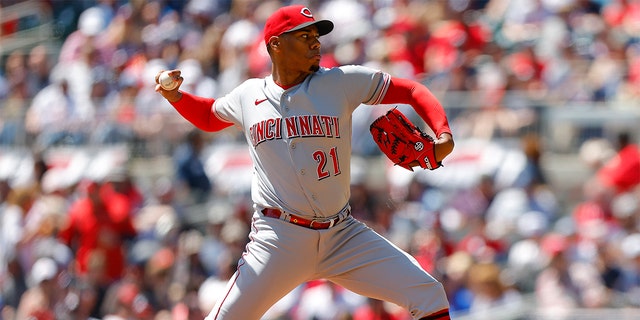 Hunter Greene #21 of the Cincinnati Reds pitches during the first inning of his MLB debut against the Atlanta Braves at Truist Park on April 10, 2022 in Atlanta, Georgia.