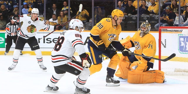 Chicago Blackhawks center Dylan Strome, left, celebrates a goal by teammate Patrick Kane against the Predators on April 16, 2022, at Bridgestone Arena in Nashville, Tennessee.