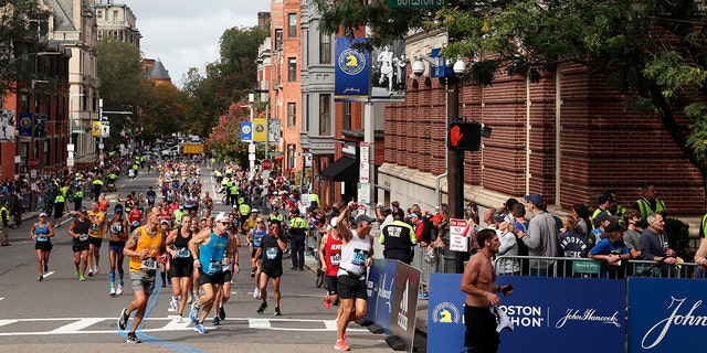 BOSTON, MASSACHUSETTS - OCTOBER 11: Runners turn onto Boylston street during the 125th Boston Marathon on October 11, 2021, in Boston, Massachusetts. 