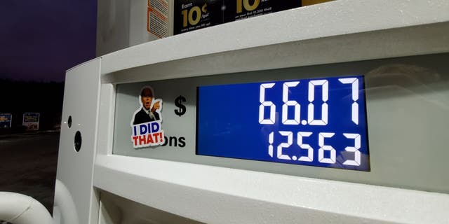 A caricature sticker of President Joe Biden pointing to high gas prices on a gasoline pump is visible in Lafayette, California, Nov. 9, 2021.