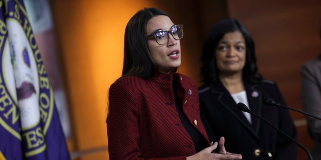 U.S. Alexandria Ocasio-Cortez (D-NY) (L), joined by Rep. Pramila Jayapal (D-WA), speaks at a news conference on banning stock trades for members of Congress