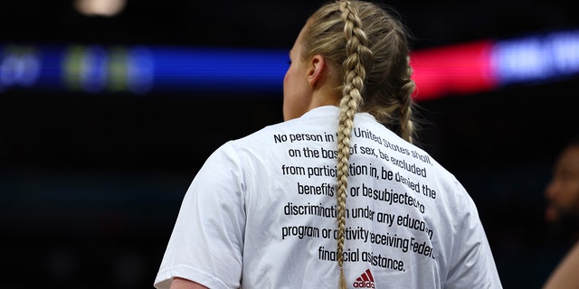 Louisville Cardinals warm-up for NCAA Women's Final Four game wearing adidas "More Is Possible" tees as part of adidas’ NIL announcement which celebrates the 50th anniversary of Title IX on Friday, April 1 at Target Center in Minneapolis, Minnesota.
