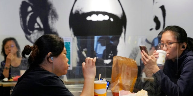 People have lunch at a restaurant in Hong Kong, Thursday, April 14, 2022.