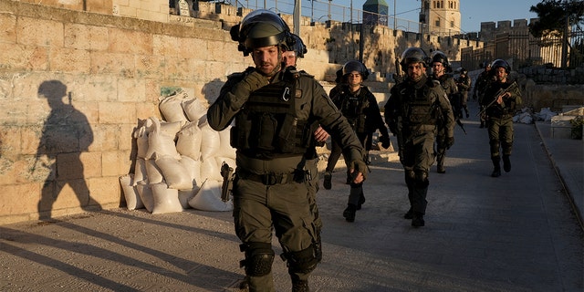 Israeli security forces gather during clashes with Palestinian demonstrators at the Al Aqsa Mosque compound in Jerusalem's Old City Friday, April 15, 2022.