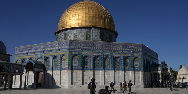 Israeli security forces take position during clashes with Palestinians demonstrators in front of the Dome of the Rock shrine at the Al Aqsa Mosque compound in Jerusalem's Old City, Friday, April 15, 2022. 