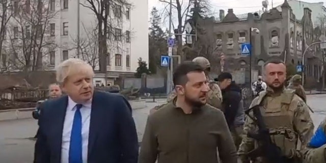 Left, U.K. Prime Minister, and Ukrainian President Volodymyr Zelenskyy walk down the streets of Kyiv. 