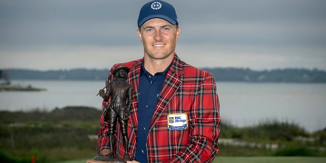 Jordan Spieth holds the championship trophy after winning the RBC Heritage golf tournament, Sunday, April 17, 2022, in Hilton Head Island, South Carolina. 