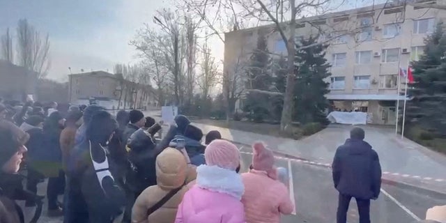 People protest the abduction of Mayor Ivan Fedorov outside the Melitopol regional administration building on March 12.