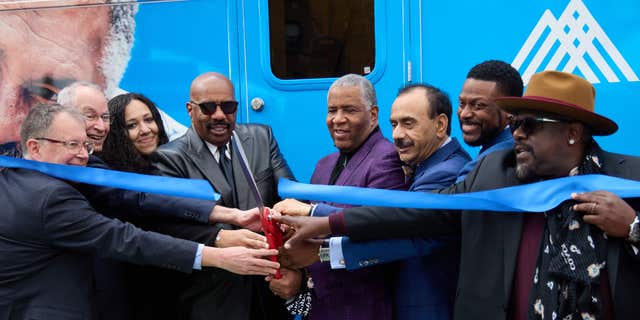 Members of Mt. Sinai Hospital Service's new mobile cancer unit cut the opening ribbon