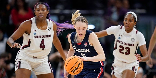 UConn's Paige Bueckers looks to get past South Carolina's Aliyah Boston and Bree Hall during the first half of a college basketball game in the final round of the Women's Final Four NCAA tournament Sunday, April 3, 2022, in Minneapolis.