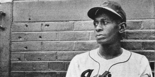 Satchel Paige rests in the Cleveland Indians' bullpen during a game at Metropolitan Stadium in Cleveland in 1948.