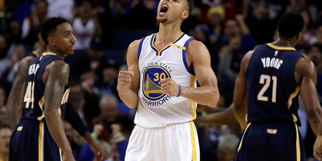 Golden State Warriors' Stephen Curry, center, celebrates a score against the Indiana Pacers Dec. 5, 2016, in Oakland, Calif.