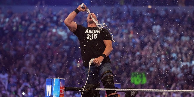 Stone Cold Steve Austin celebrates with beer during WrestleMania at AT&amp;T Stadium in Arlington, Texas, on Apr 3, 2022.