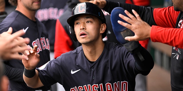 Cleveland Guardians' Steven Kwan is congratulated after scoring against the Kansas City Royals during the first inning of a baseball game, Monday, April 11, 2022, in Kansas City, Mo.