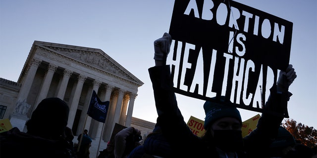 Abortion rights activists protest outside the Supreme Court building in Washington, D.C., Dec. 1, 2021.