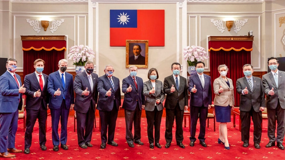 Members of an American Congressional delegation pose for a photo with Taiwan's President Tsai Ing-wen and other Taiwanese officials