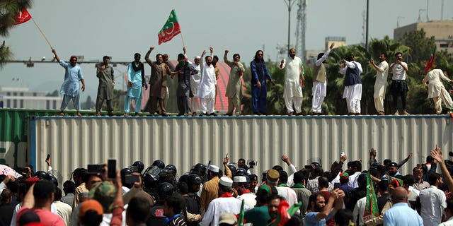 Supporters of ruling party Pakistan Tehreek-e-Insaf (PTI) chant slogans during a protest in Islamabad, Pakistan, Sunday, April 3, 2022. Pakistan's embattled Prime Minister Imran Khan said Sunday he will seek early elections after sidestepping a no-confidence challenge and alleging that a conspiracy to topple his government had failed. (AP Photo/Rahmat Gul)